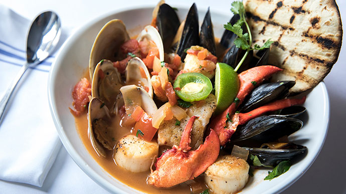 seafood, mussels, crab, clams, presented nicely in dish at restaurant in Barnstable, MA