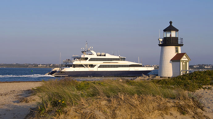ferry boat passing prant point lighthouse and harbor on nantucket island on the cape